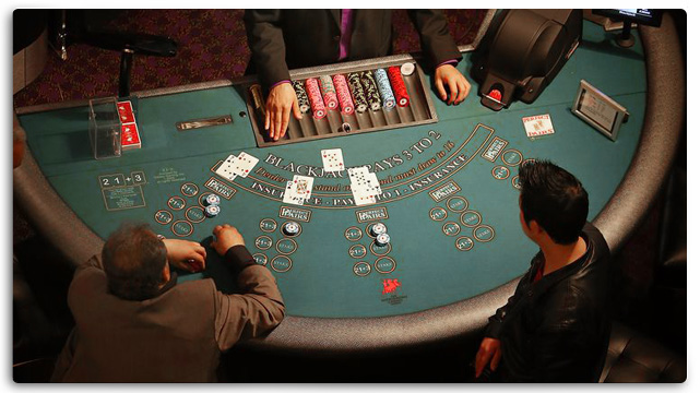 Two People Playing Blackjack Table in Casino
