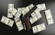 Money And A Gun On Table