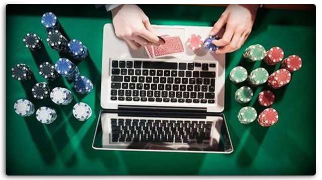 Laptop on Casino Gaming Table, surrounded by poker chips