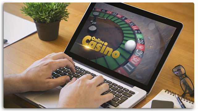 Person on laptop playing online casino game