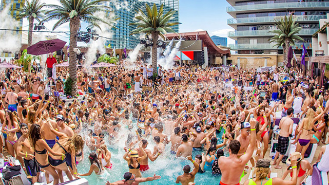 Big Crowd of People at Las Vegas Dayclub Pool, Palm Trees, Casinos in Background