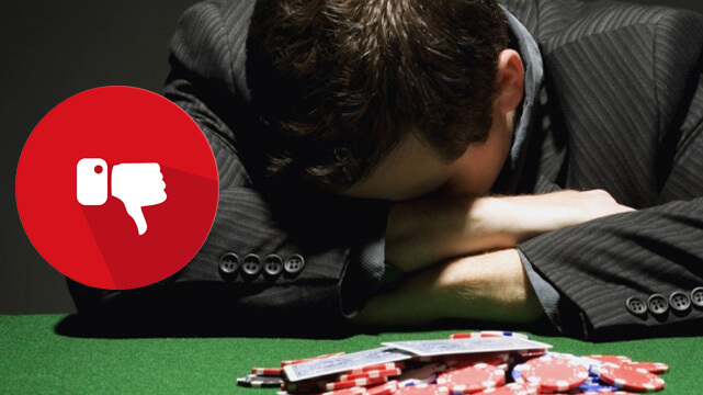 Guy with Head Down Upset Playing Casino Table Game, Red Thumbs Down