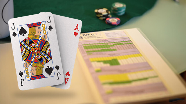 Blackjack Strategy Book on Table, Two Poker Cards