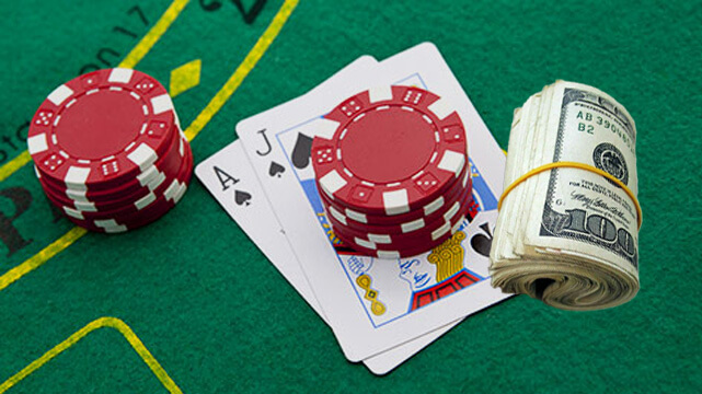 Casino Table Game with Poker Cards and Casino Chips, Roll of Money