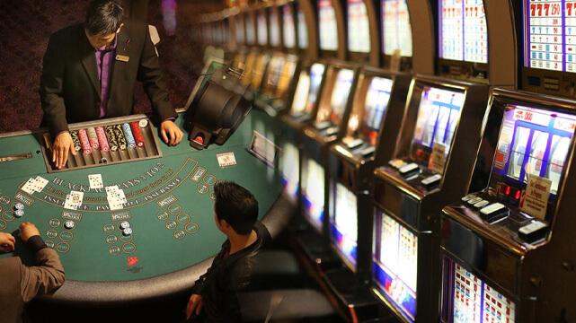 Split Image of Blackjack Casino Game and Slot Machines in Casino