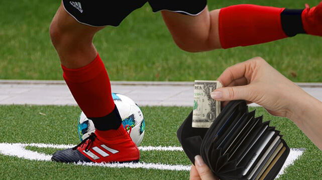 Soccer Player About to Kick Soccer Ball, Hand Pulling Money Out of Wallet