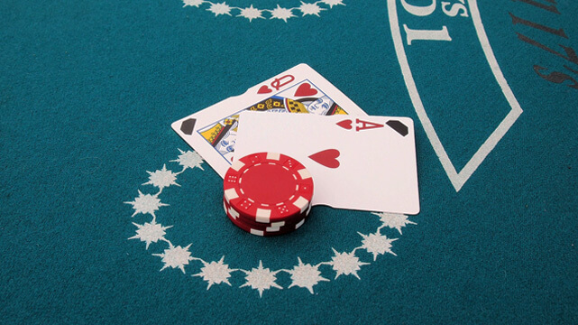 Two Blackjack Cards and Casino Chips on Blackjack Table