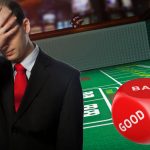 Casino Craps Table, Red Dice, Man With Hand Over Face Disappointed