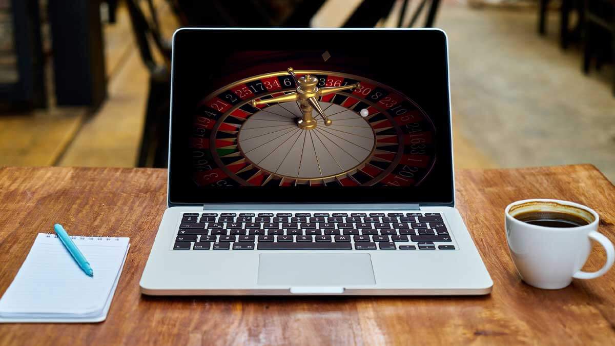 Laptop Computer on Table, Roulette Wheel on Computer Screen