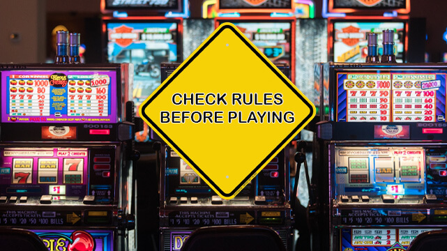 Slot Machines in Casino, Caution Sign Reading Check Rules Before Playing