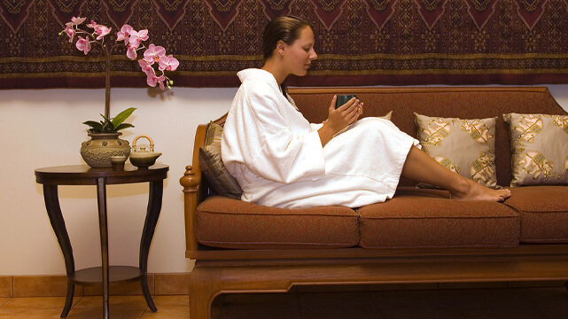Woman In Spa Resort Sitting on Couch