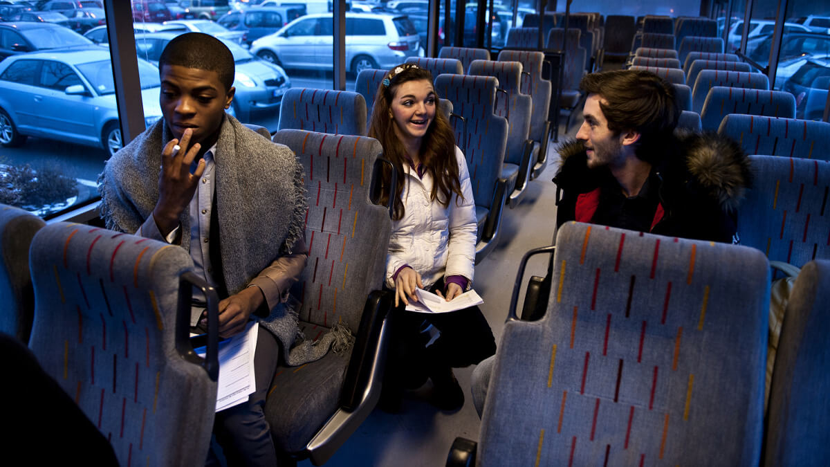Three People Sitting in Bus