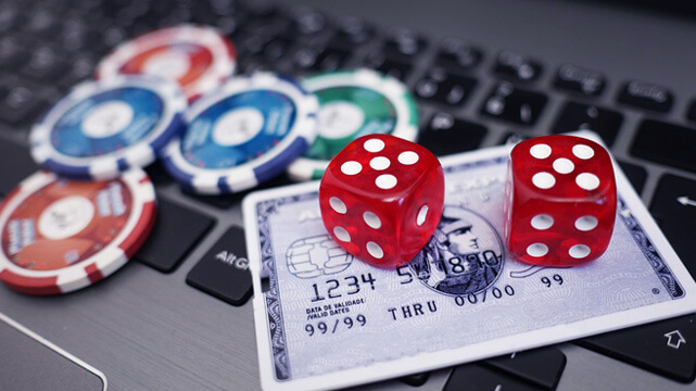 Casino Chips, Credit Card, Dice on Laptop
