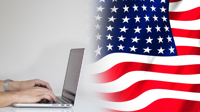 Hands Typing on Laptop, American Flag