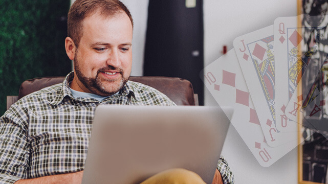 Guy Using Laptop, Poker Cards Spread