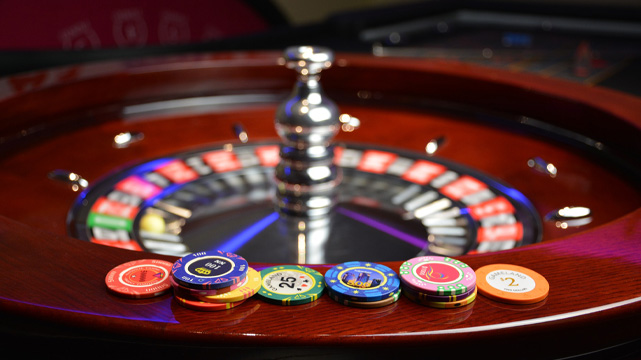Casino Roulette Wheel with Casino Chips on the Side