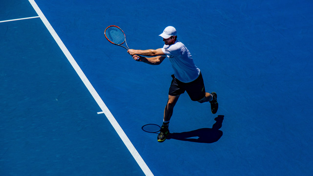 Tennis Player on the Court Holding Out Racket