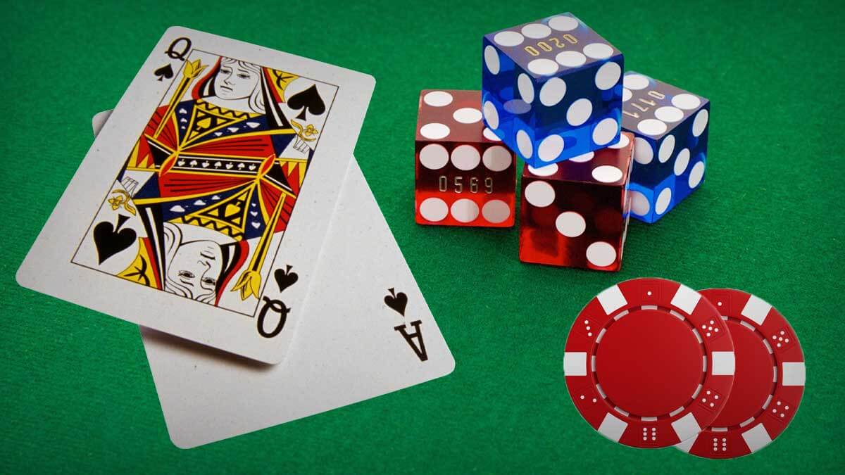 Two Poker Cards, Casino Dice, and Poker Chips on Table