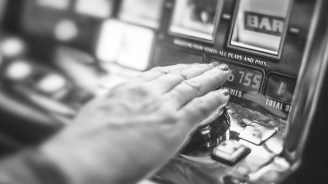 Closeup of Hand Playing Slot Machine