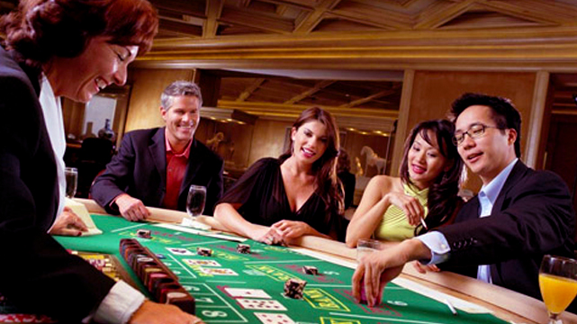 Group of Happy People Playing Baccarat