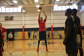 Basketball Player Shooting a Basket in Gym
