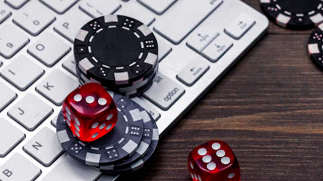 Dice and Casino Chips on a Laptop Keyboard