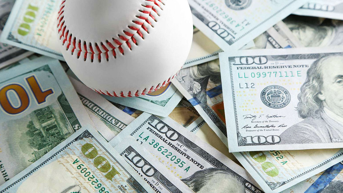 Baseball Placed on Top of Hundred Dollar Bills
