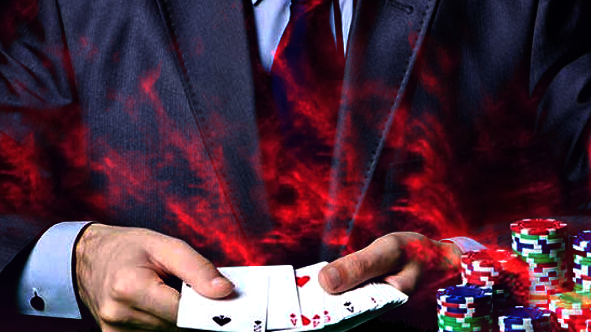 Closeup of a Man in a Suit Holding Playing Cards