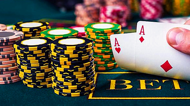 Holdem Pocket Aces Next to a Stack of Poker Chips