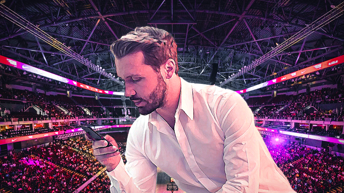Man on Cell Phone With an NBA Stadium Background