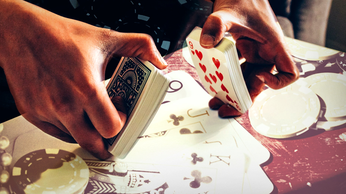 Closeup of Hands Shuffling Cards With Poker Themed Design Table