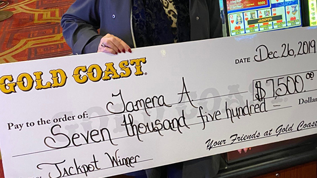 Woman Holding Up Oversized Check From Jackpot Win