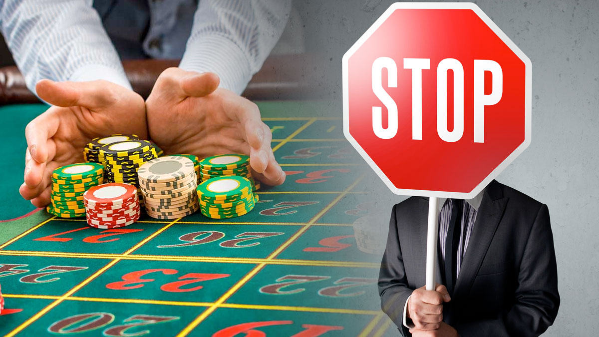 Man Holding Up a Stop Sign and a Man Pushing a Pile of Casino Chips