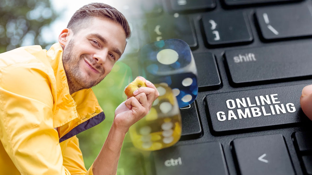 Happy Man Eating an Apple and a Laptop With an Online Gambling Key