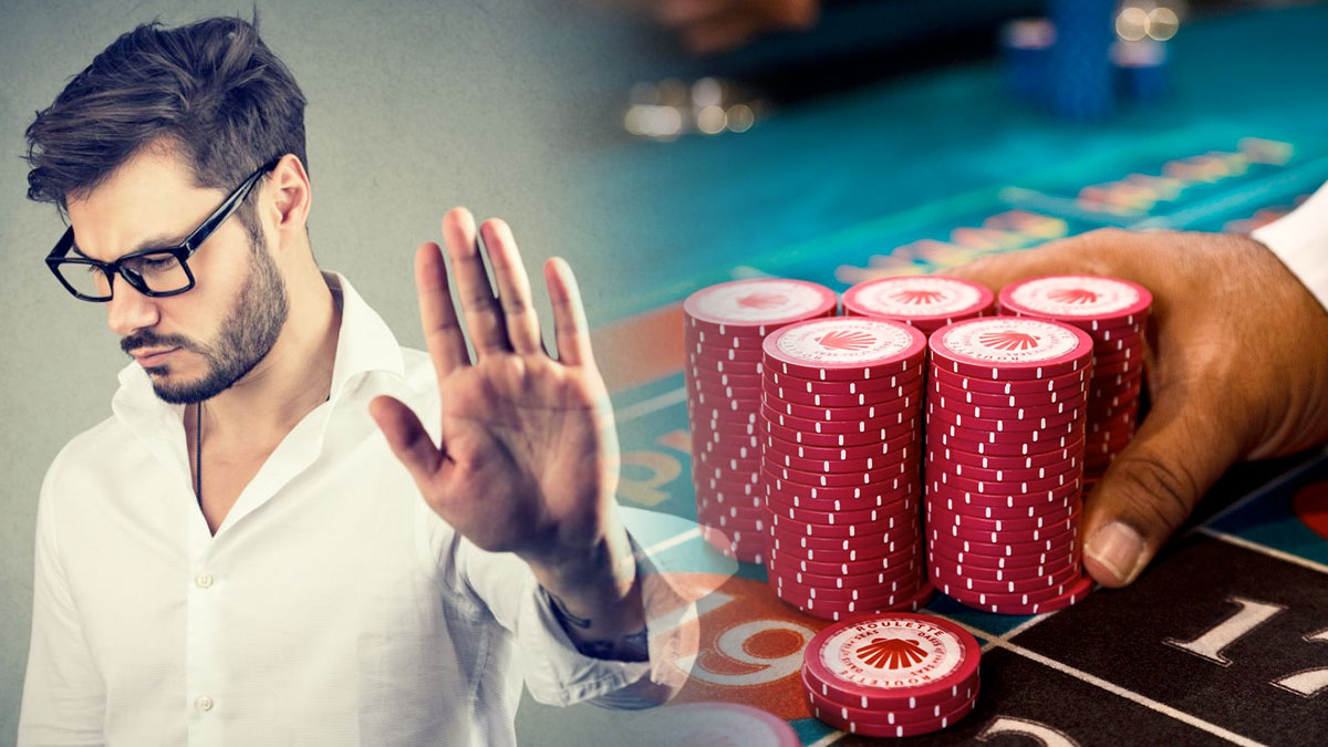 Man Holding Hand Palm Out and a Casino Background