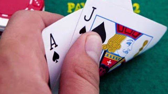 Closeup of a Man Holding a Blackjack Hand