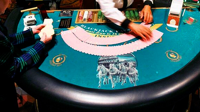 Blackjack Dealer Fanning Out Cards on the Table