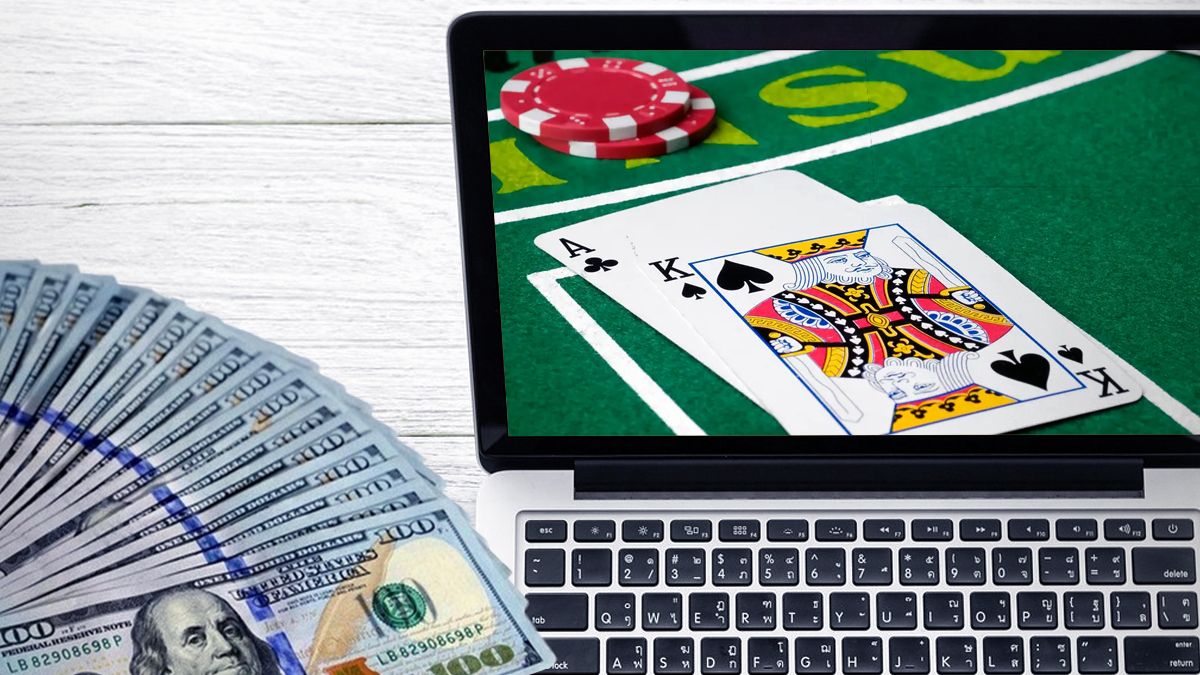 Money and Laptop With a Blackjack Image