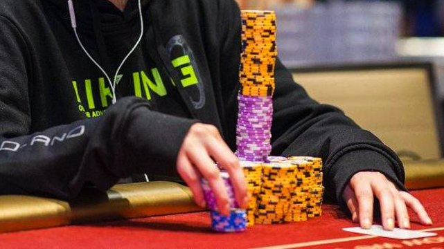 Person at a Poker Table With a Large Stack of Chips
