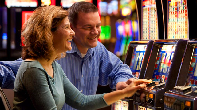 Couple Gambling on a Slot Machine