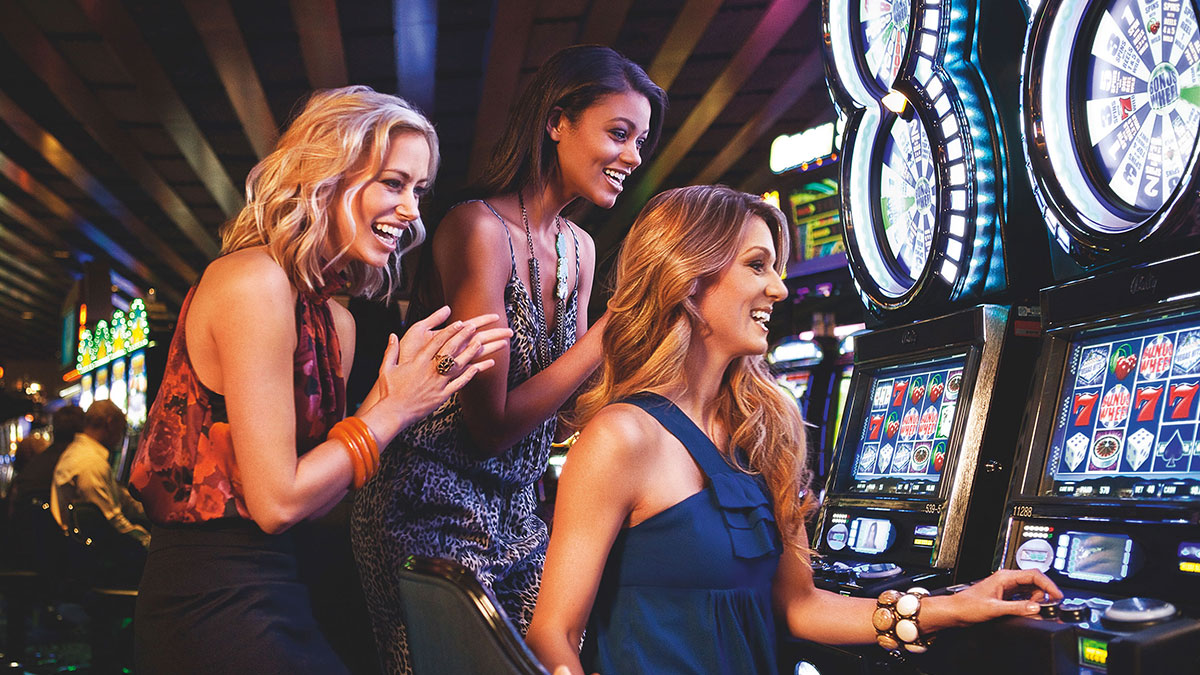Three Women Playing Slots Machines