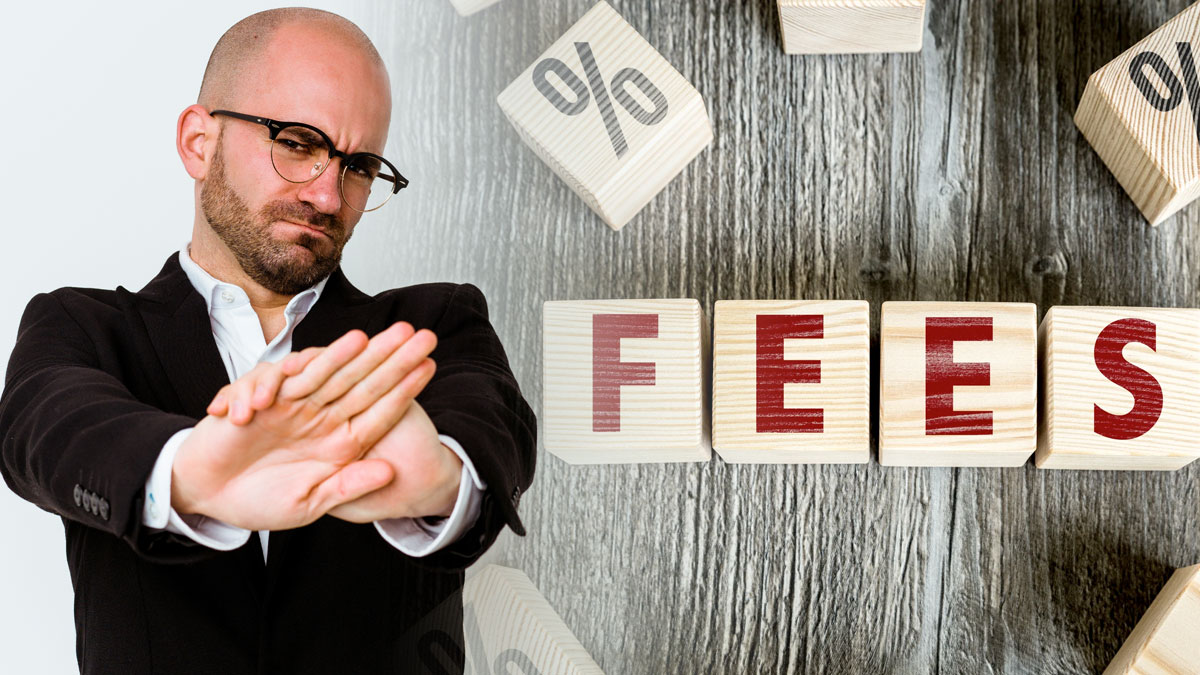 Man With Hands Crossed In Front Of Him With Blocks Spelling Fees to the Right