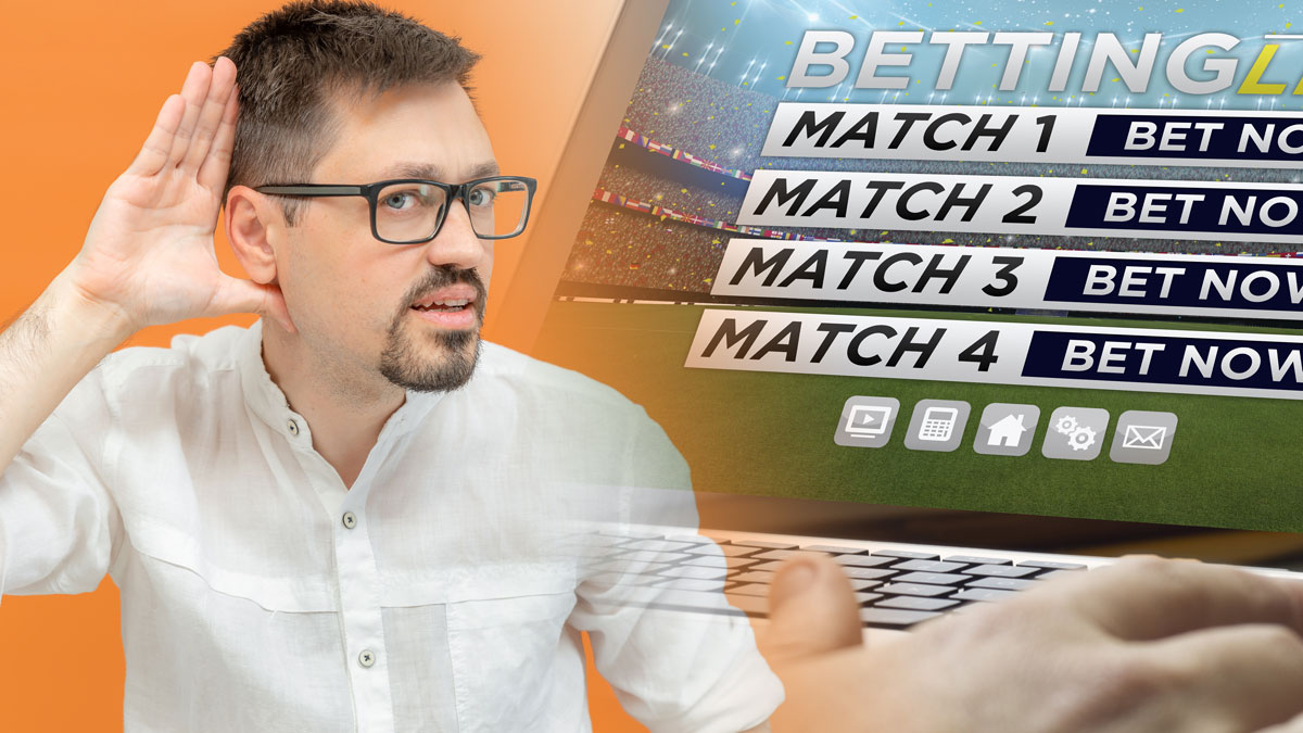 Man With Hand to Ear and Sports Betting tab Open on Laptop