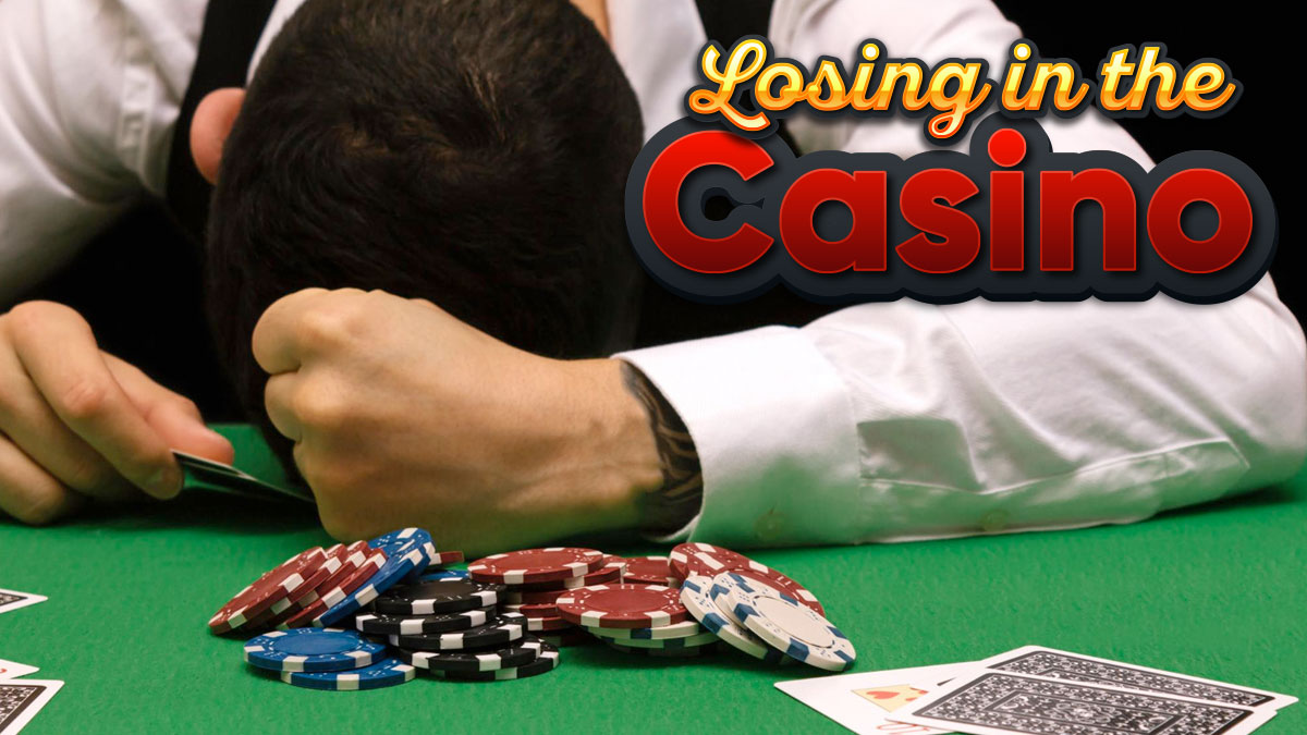 Man With Head Down on a Casino Table With a Pile of Chips in Front of Him
