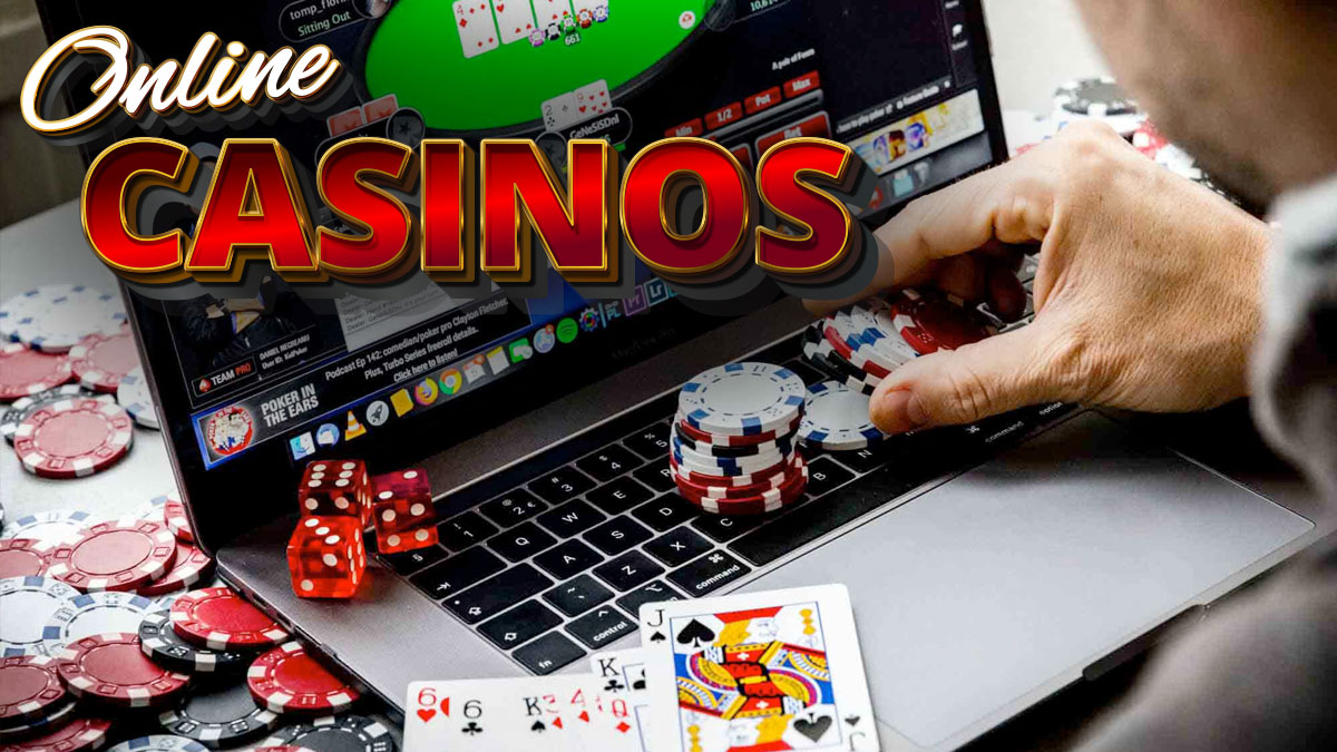 Online Casino on a Laptop With CHips and Cards Around it and Someone Placing Chips on the Keyboard
