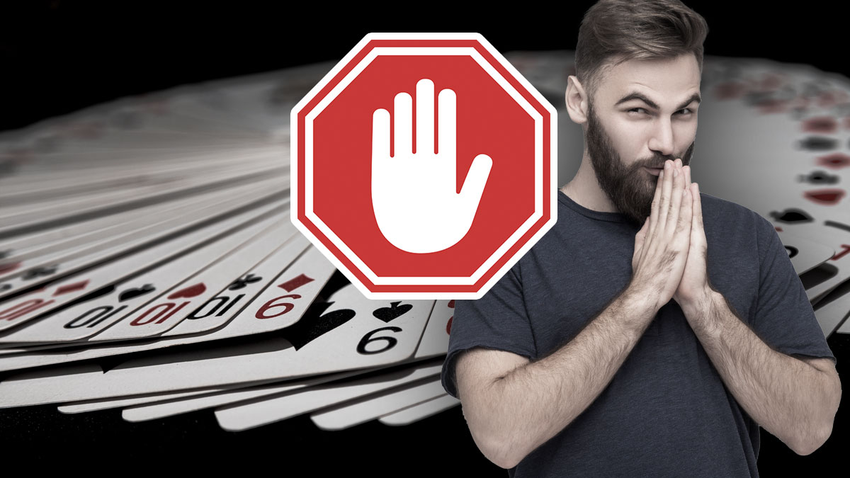 Cards in a Pile in the Background Man Holding Hands Together on Right Red Stop Sign With a Hand Showing Stop in the Middle