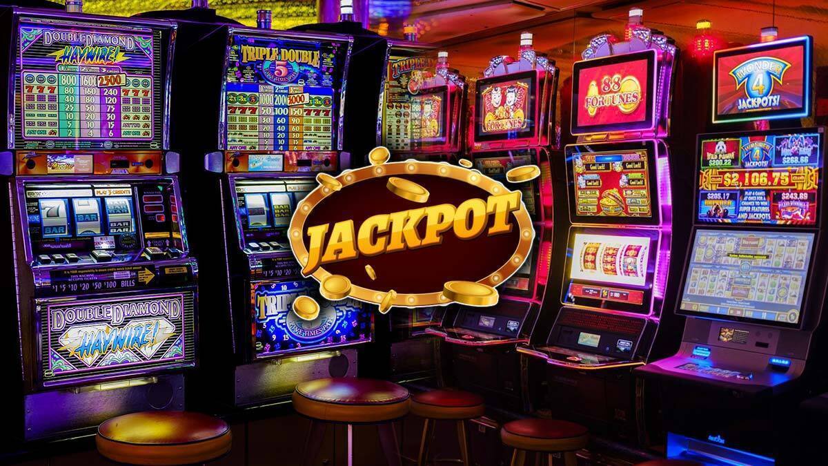 Two Rows of Slot Machines With a Jackpot Logo in Center