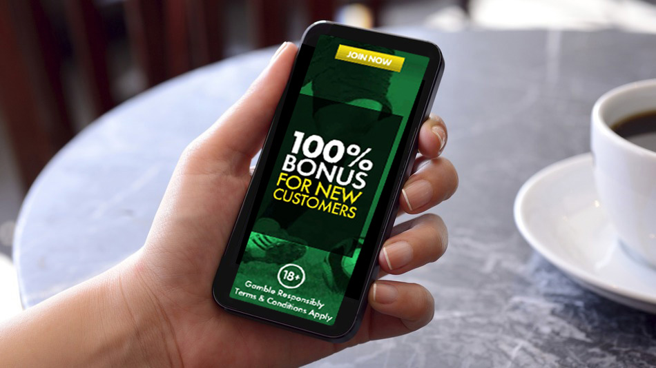 Hand Holding Mobile Phone, With Bonus Offer on Screen, Online Casino