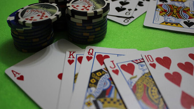 Stacks of Casino Chips, Poker Cards Spread Out on Table