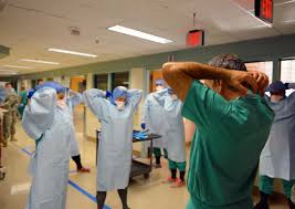 Medical Staff Wearing Personal Protective Equipment and Stretching